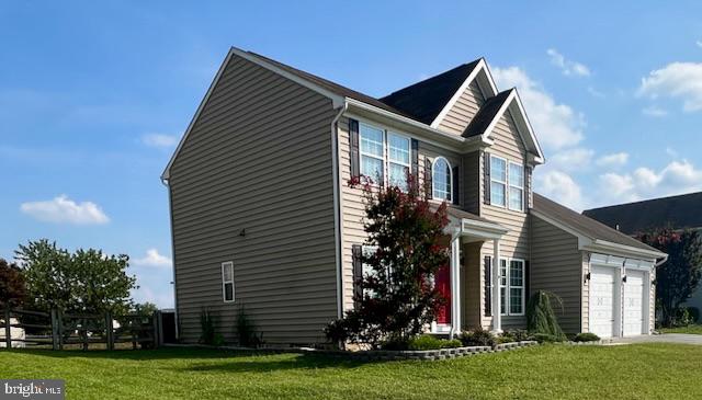 83 Zelkova Road Smyrna, DE 19977 - Photo 2 of 117 a front view of a house with a yard and garage