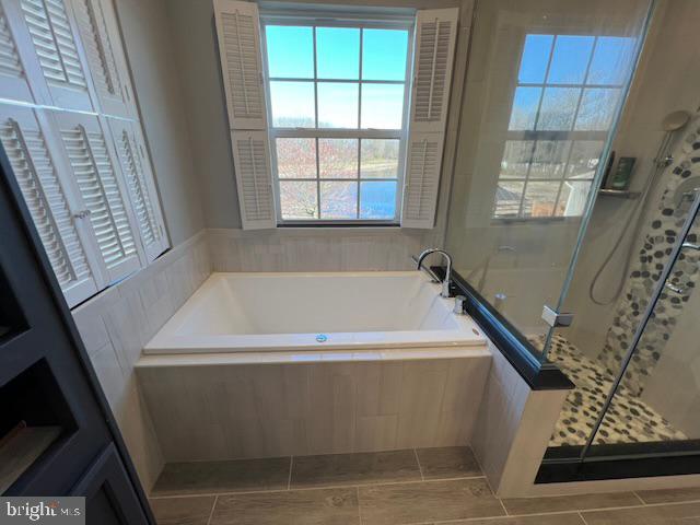 83 Zelkova Road Smyrna, DE 19977 - Photo 53 of 117 a white bath tub sitting in a bathroom next to a window