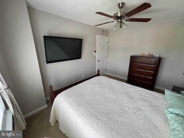 83 Zelkova Road Smyrna, DE 19977 - Photo 58 of 117 a bedroom with a bed and a chandelier