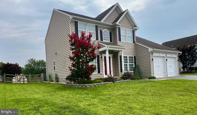 83 Zelkova Road Smyrna, DE 19977 - Photo 6 of 117 a front view of a house with a garden and plants