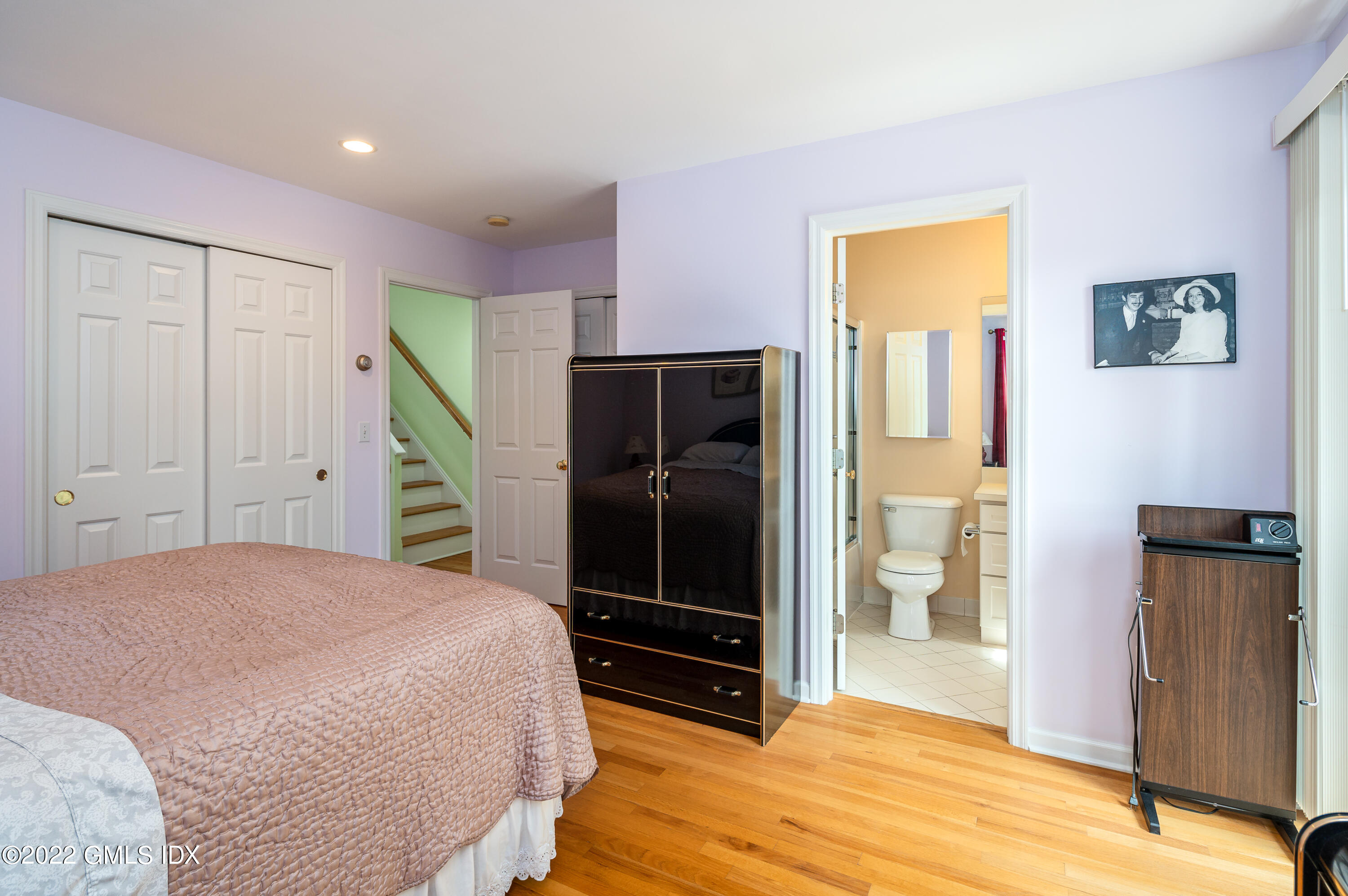 53 Rodwell Avenue, Unit B Greenwich, CT 06830 - Photo 20 of 33 a bed room with a bed and a mirror