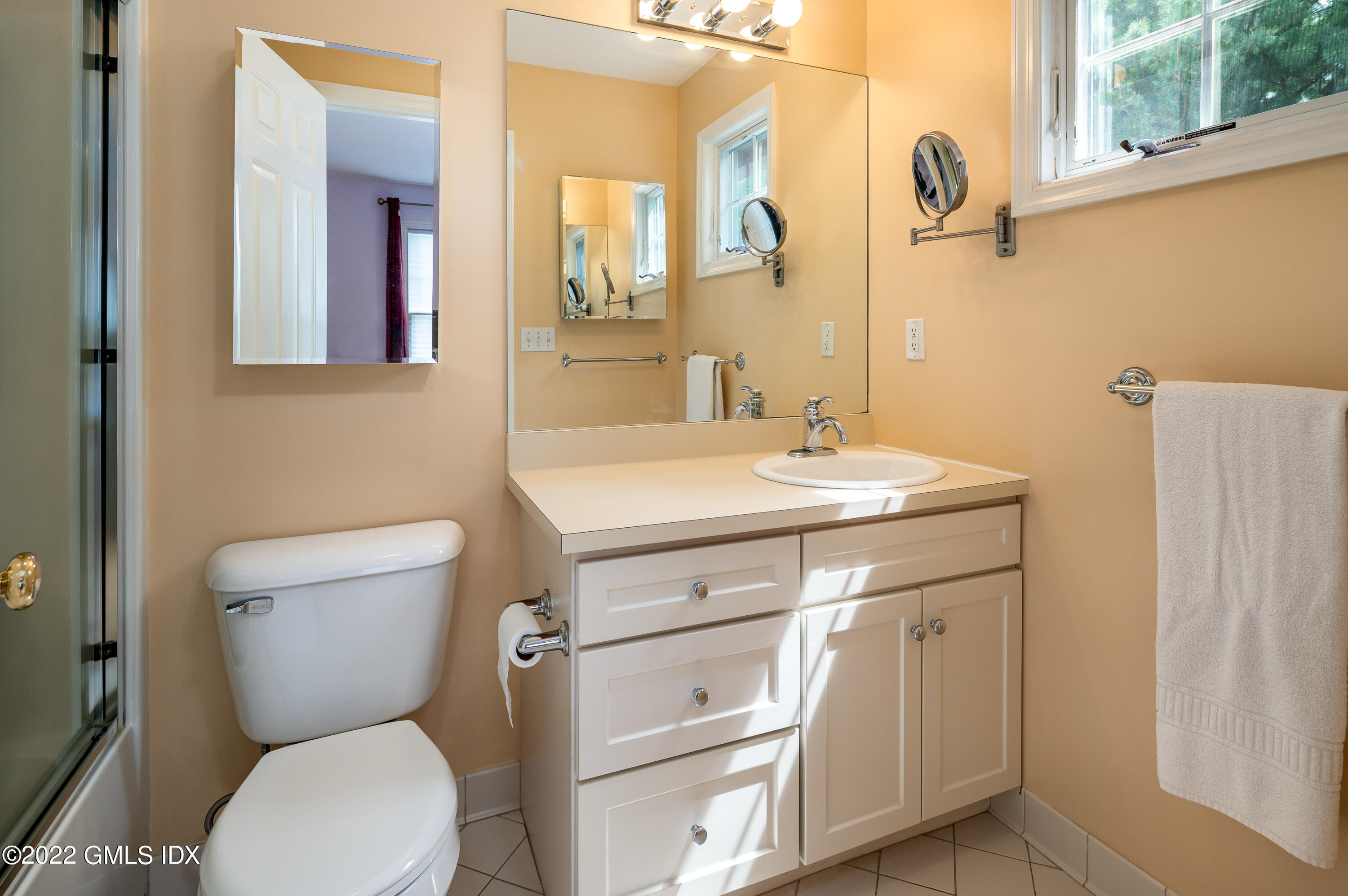 53 Rodwell Avenue, Unit B Greenwich, CT 06830 - Photo 21 of 33 a bathroom with a toilet sink and mirror