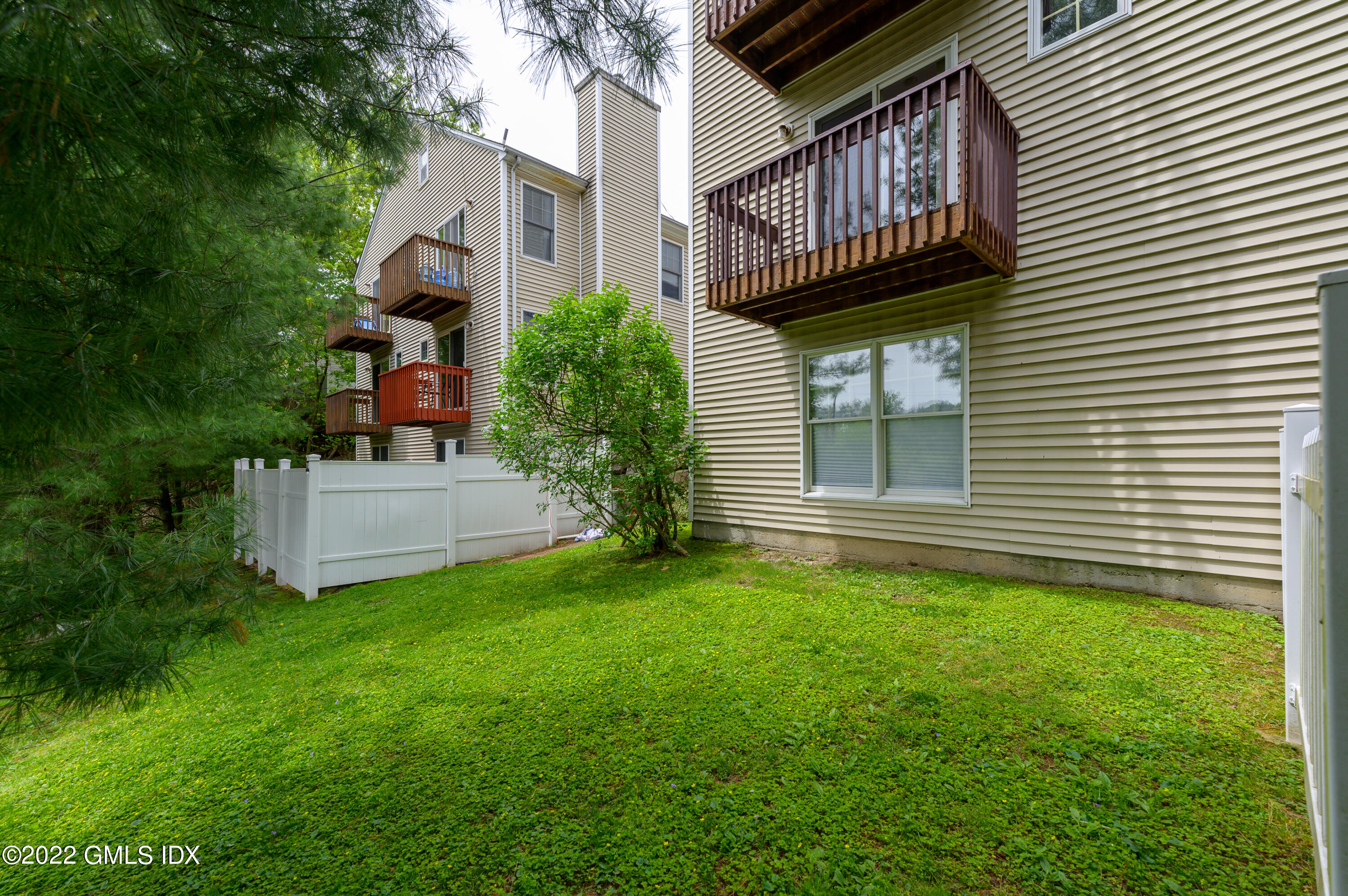53 Rodwell Avenue, Unit B Greenwich, CT 06830 - Photo 28 of 33 a view of a house with a yard and sitting area