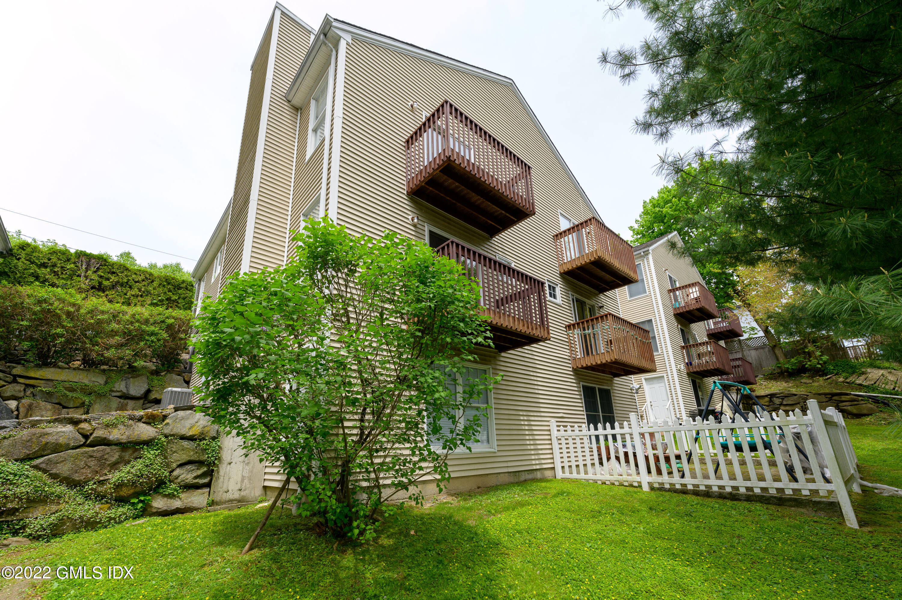 53 Rodwell Avenue, Unit B Greenwich, CT 06830 - Photo 29 of 33 a front view of a house with a yard