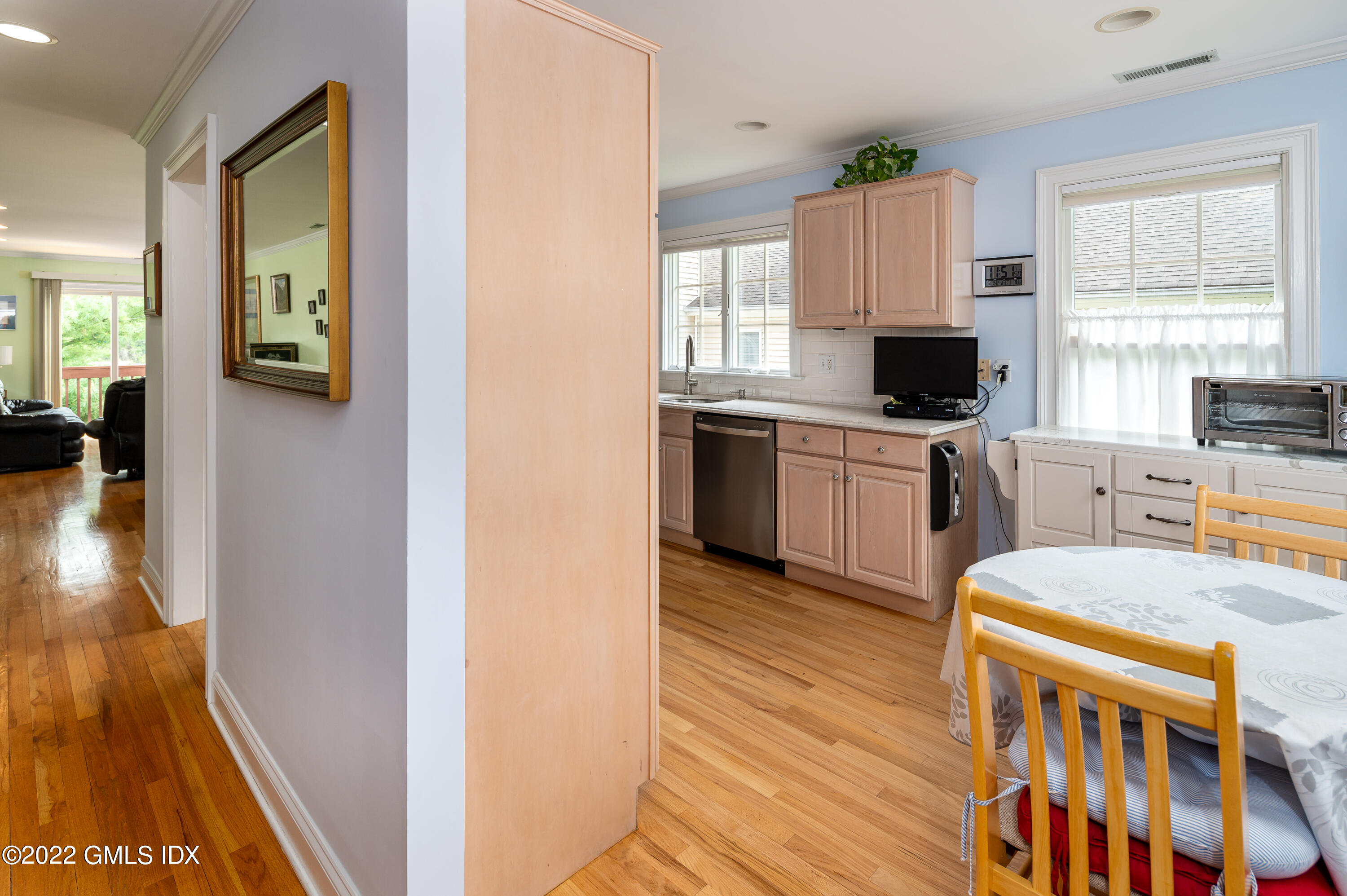 53 Rodwell Avenue, Unit B Greenwich, CT 06830 - Photo 3 of 33 a kitchen with stainless steel appliances a stove top oven a sink a refrigerator white cabinets and wooden floor