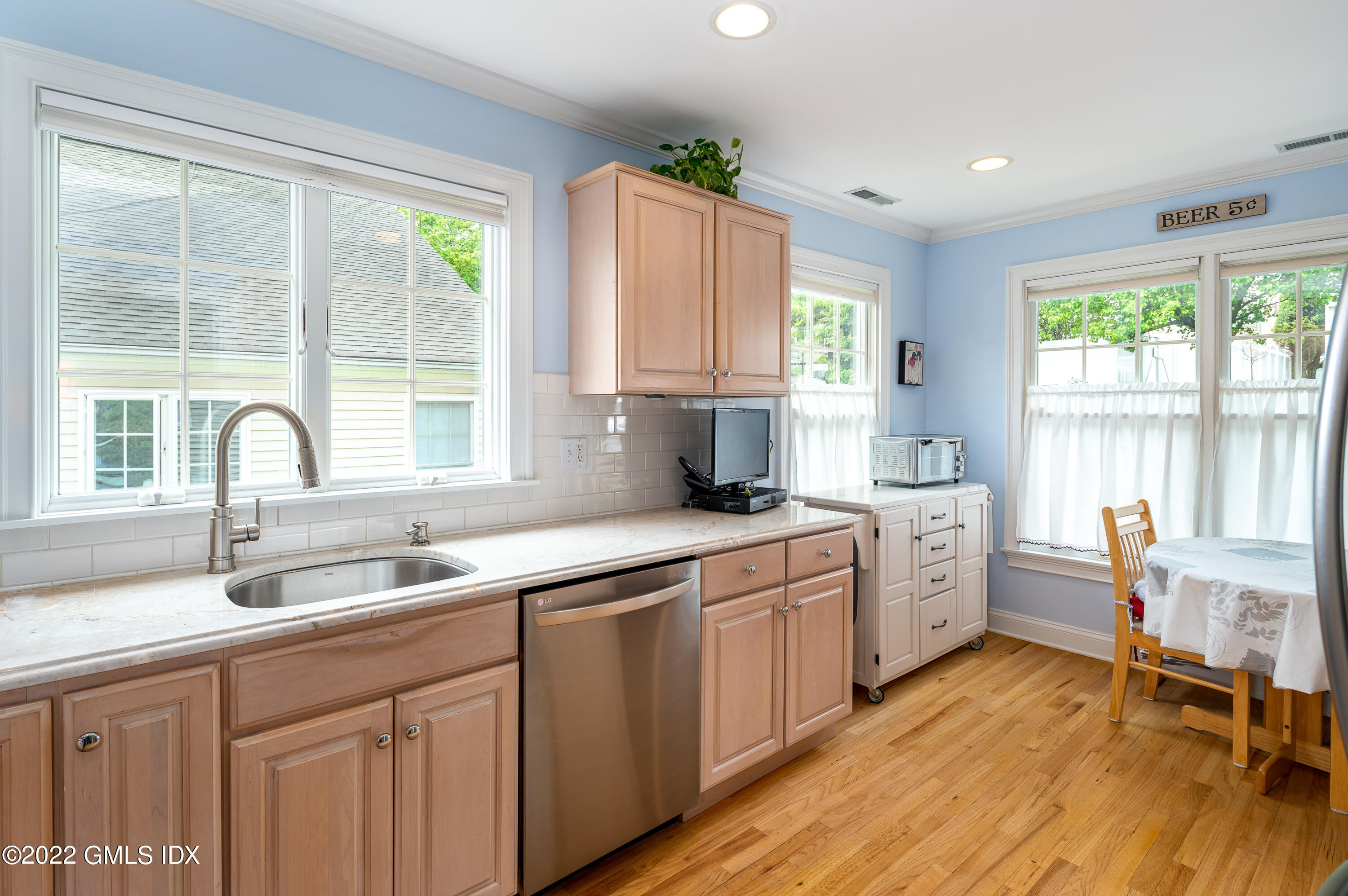 53 Rodwell Avenue, Unit B Greenwich, CT 06830 - Photo 7 of 33 a kitchen with sink cabinets and wooden floor