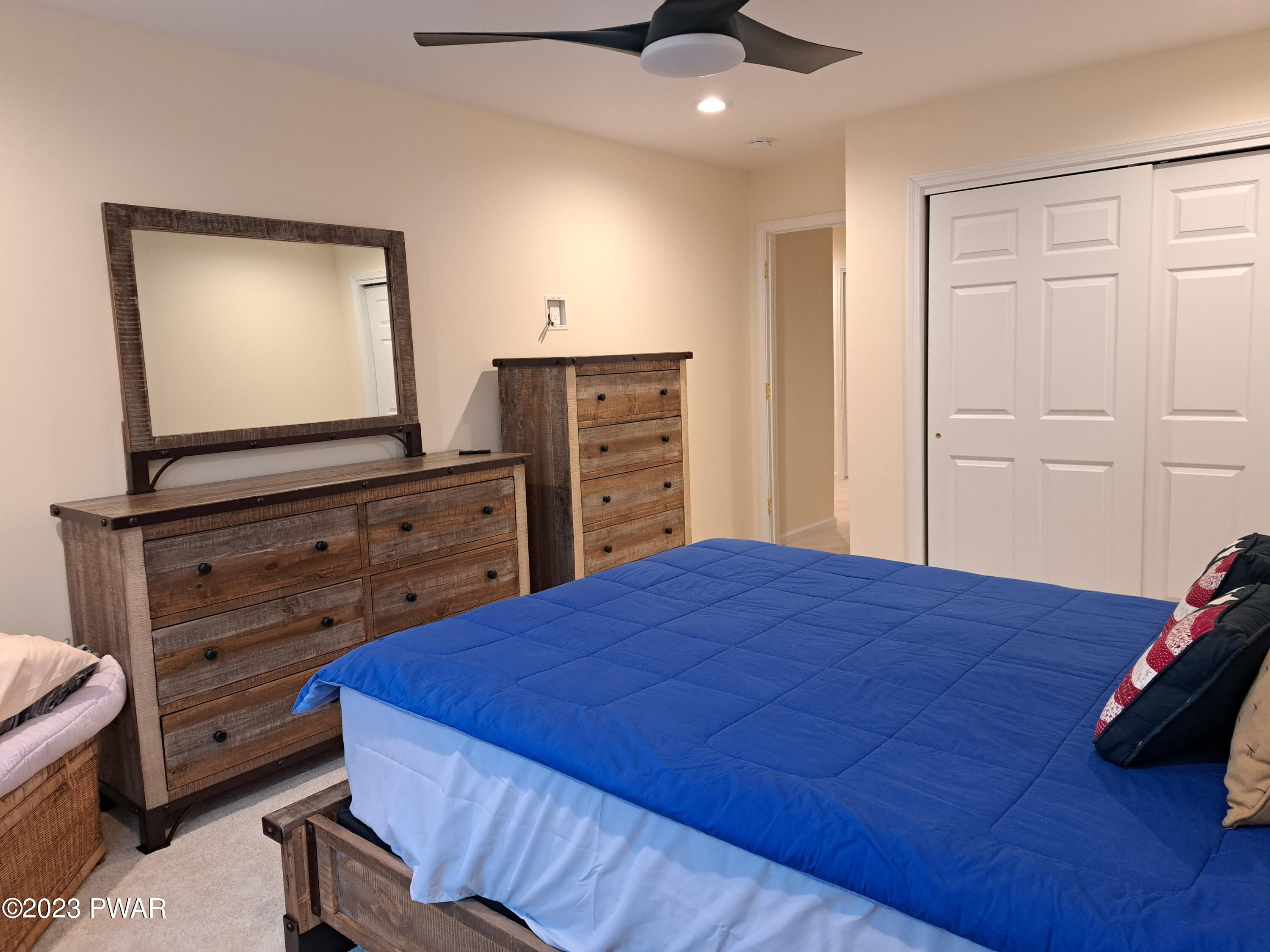 806 MacIntosh Way Matamoras, PA 18336 - Photo 42 of 53 a bedroom with a bed and a flat tv screen on dresser