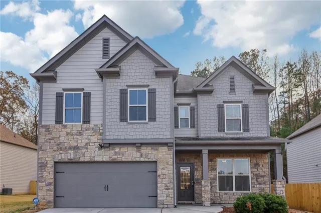 a front view of a house with a garage
