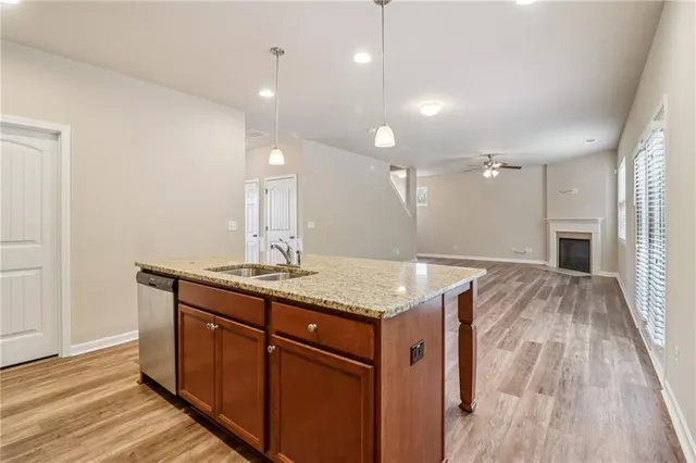 a bathroom with a granite countertop sink a toilet and a mirror