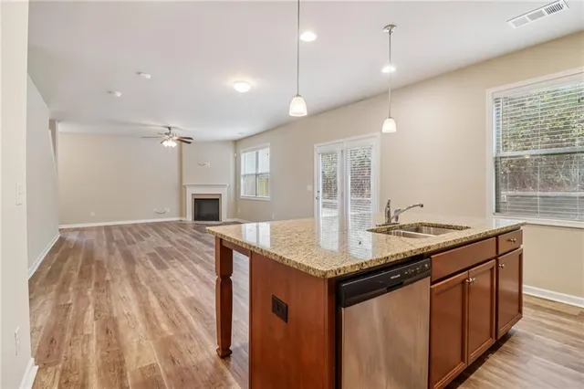 a kitchen with sink cabinets and wooden floor
