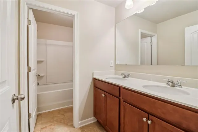 a bathroom with a granite countertop sink mirror and double