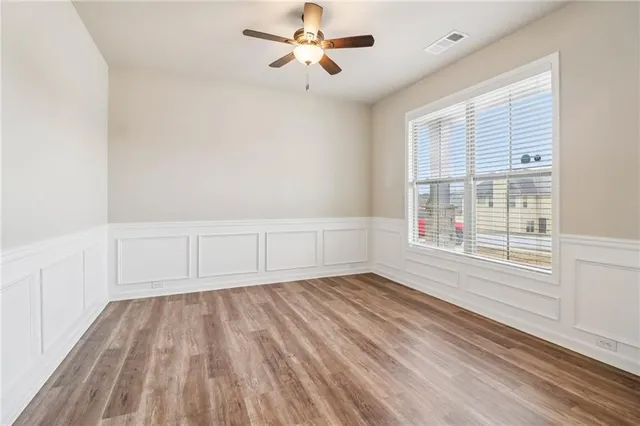 wooden floor in an empty room with a window