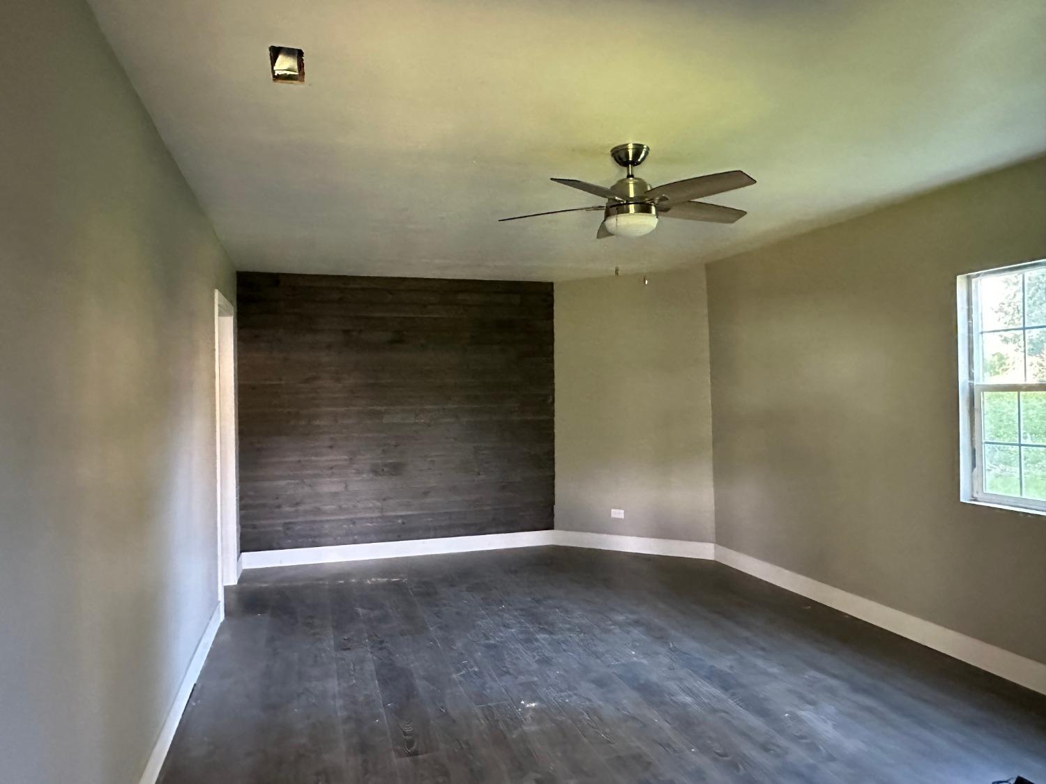 14055 River Road Walnut Grove, CA 95690 - Photo 12 of 55 an empty room with windows and fan