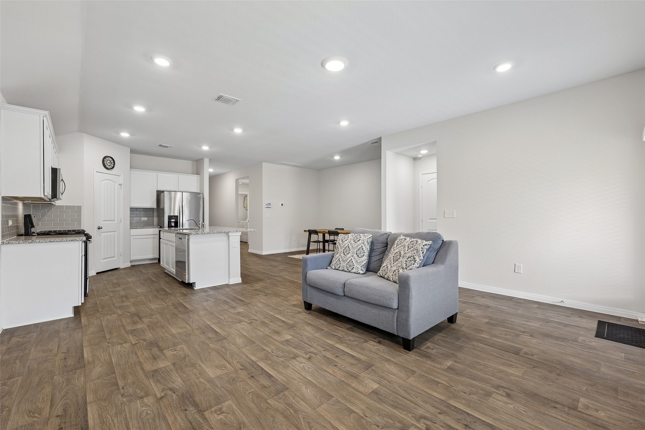 19805 Abigail Fillmore Road Manor, TX 78653 - Photo 6 of 40 An open concept living area transitions fluidly into a sleek, modern kitchen, perfect for effortless entertaining.