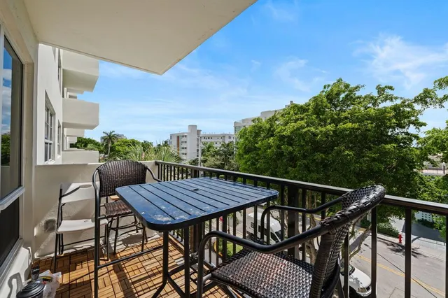 a view of balcony with wooden floor and outdoor seating