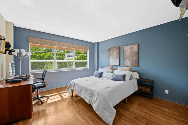 a bedroom with a bed and a large window