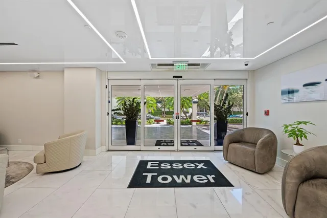 a living room with furniture and a floor to ceiling window