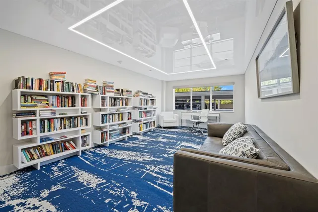 a living room with furniture and a book shelf