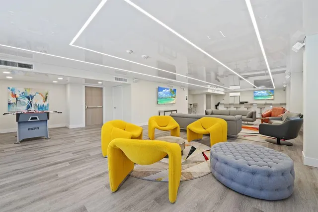 a living room with lots of furniture and a chandelier
