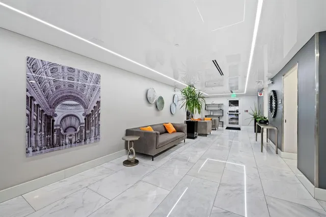 a living room with furniture a couch and dresser