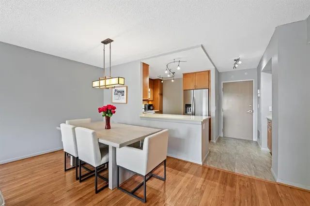 a view of a dining room with furniture wooden floor and chandelier