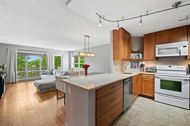 a kitchen with a stove sink and cabinets