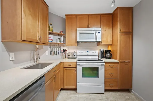 a kitchen with a sink stove and refrigerator