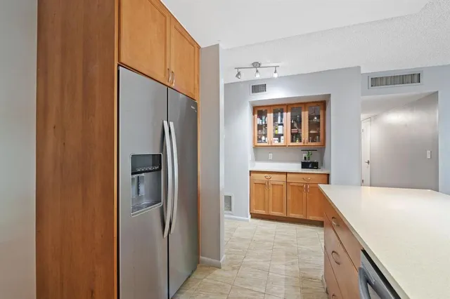 a large kitchen with a refrigerator and a sink
