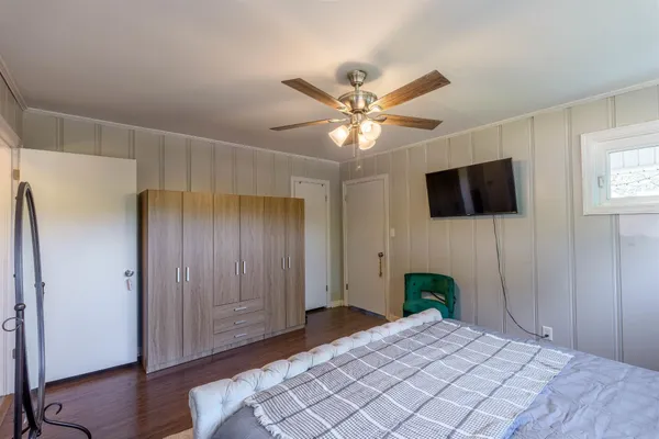 a bedroom with a bed and a flat screen tv
