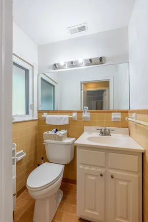 a bathroom with a sink toilet and mirror