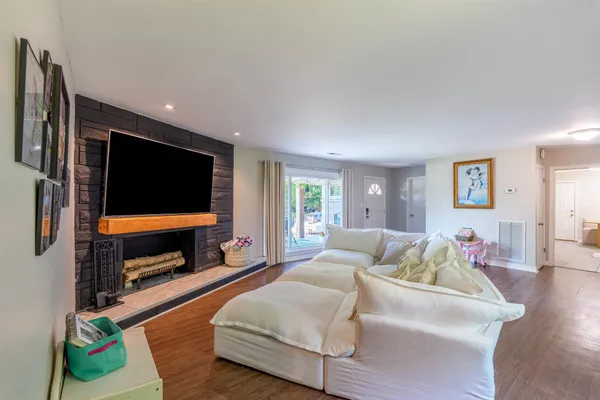 a living room with fireplace furniture and a flat screen tv