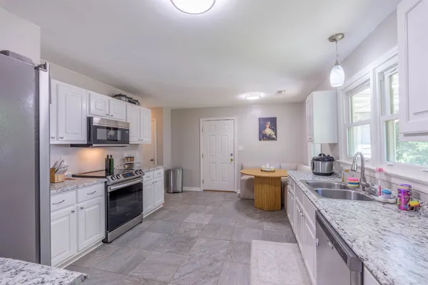 a kitchen with a sink stove and wooden cabinets