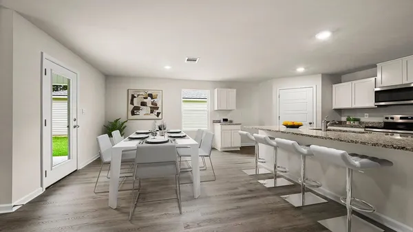 a large kitchen with granite countertop a stove top oven a sink a counter space and cabinets