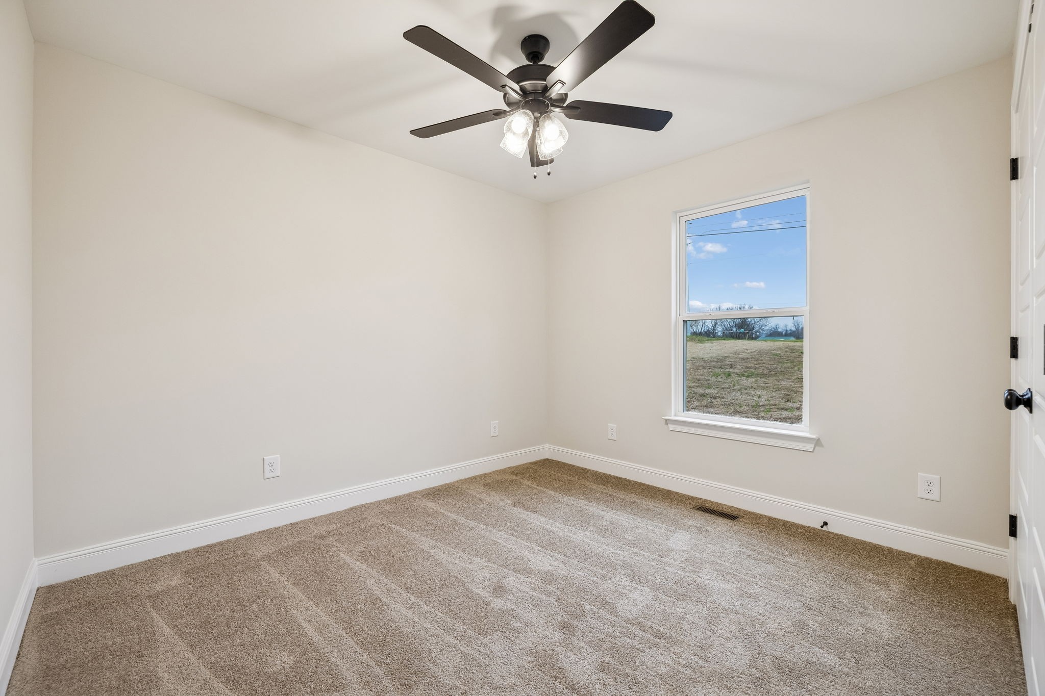 1015 Landing Lane Adams, TN 37010 - Photo 21 of 27 an empty room with a window and a fan