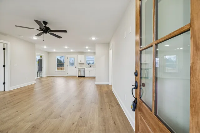 a view of a hallway with wooden floor
