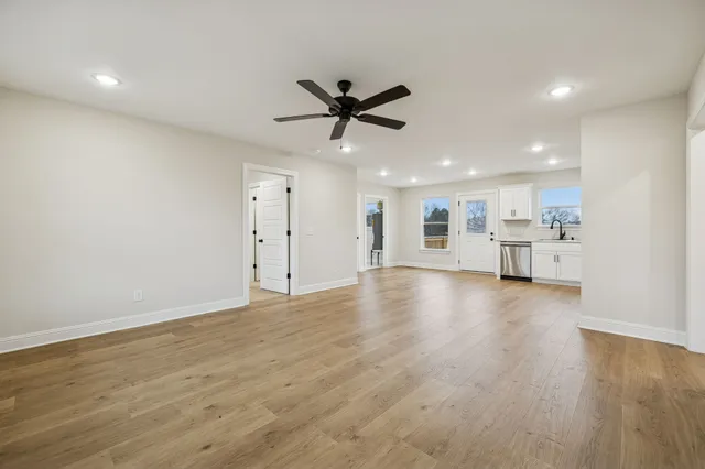 a view of an empty room with a kitchen