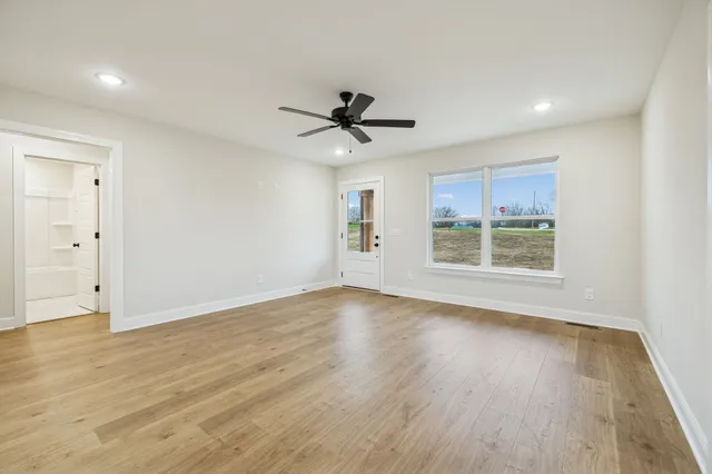 wooden floor in an empty room with a window