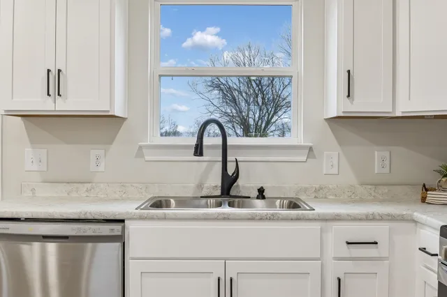 a view of empty room with wooden floor and windows