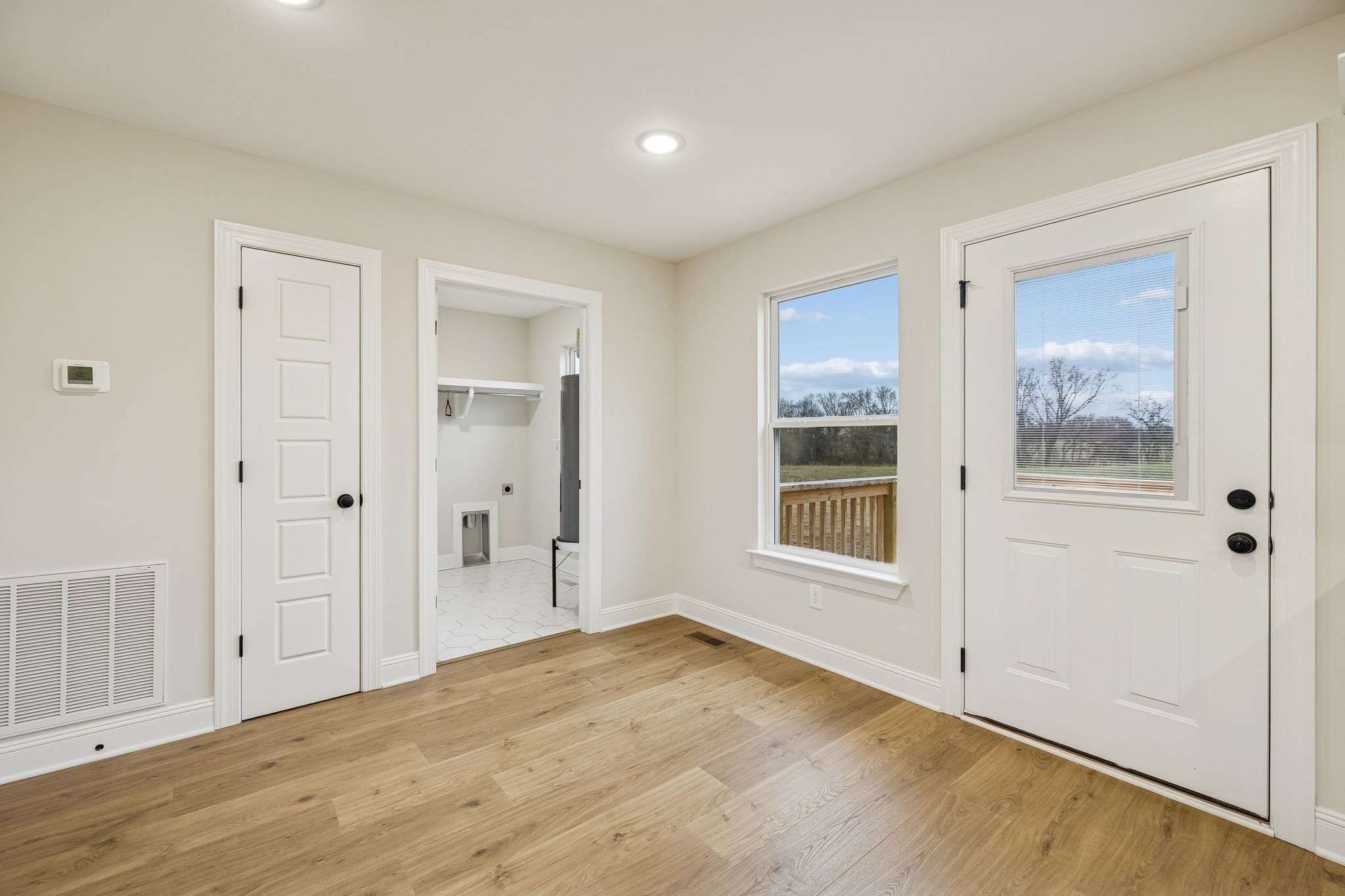 1015 Landing Lane Adams, TN 37010 - Photo 10 of 27 a view of empty room with wooden floor and windows