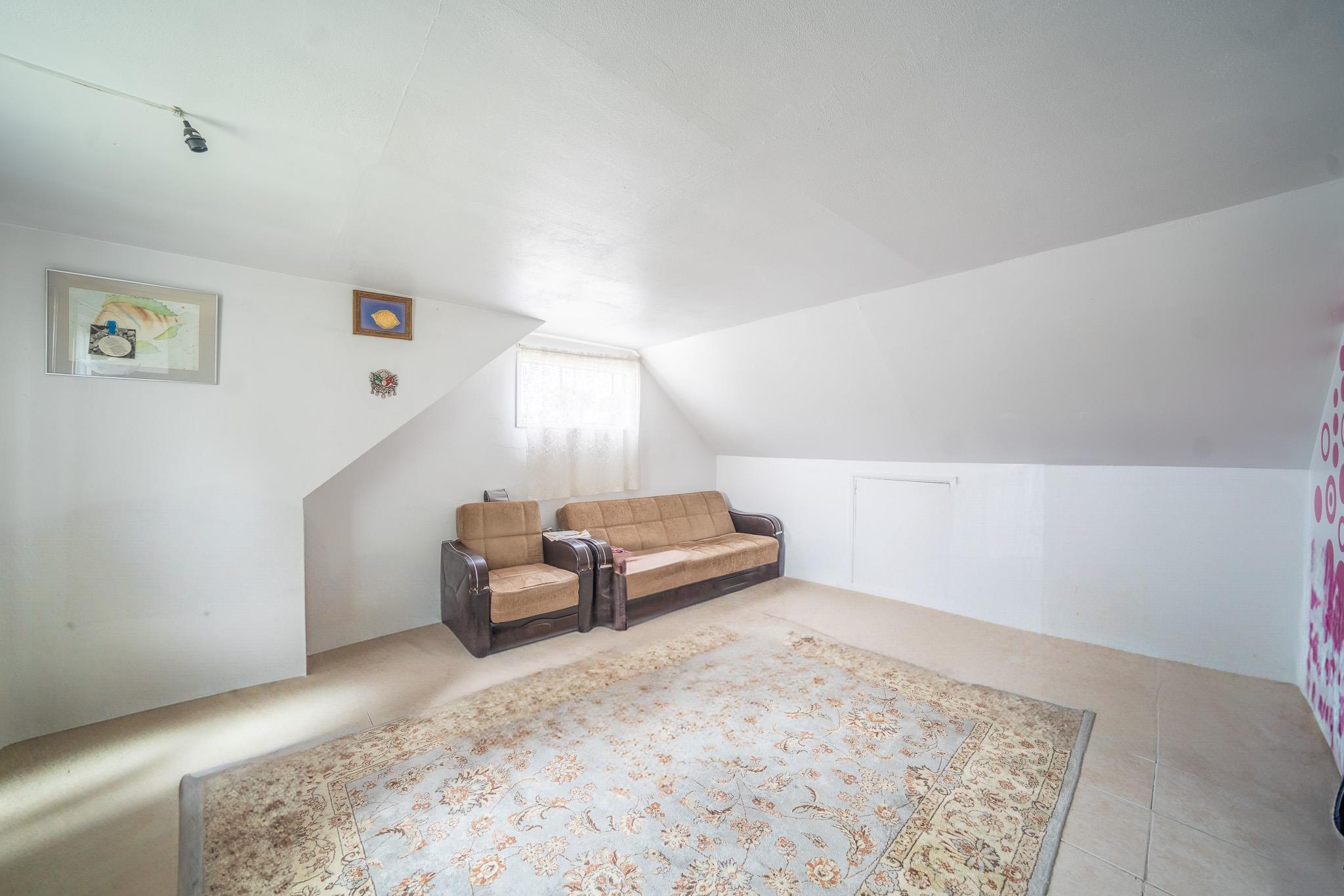 47 Cardinal Road Levittown, NY 11756 - Photo 23 of 27 Living area featuring vaulted ceiling and carpet flooring
