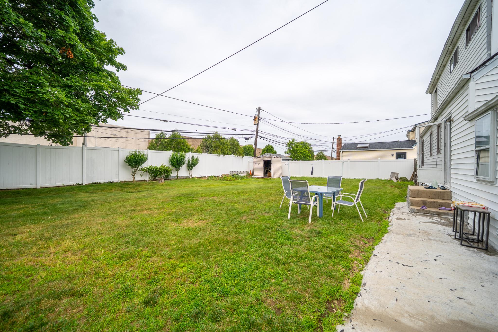 47 Cardinal Road Levittown, NY 11756 - Photo 25 of 27 Fenced backyard featuring a shed and a patio area