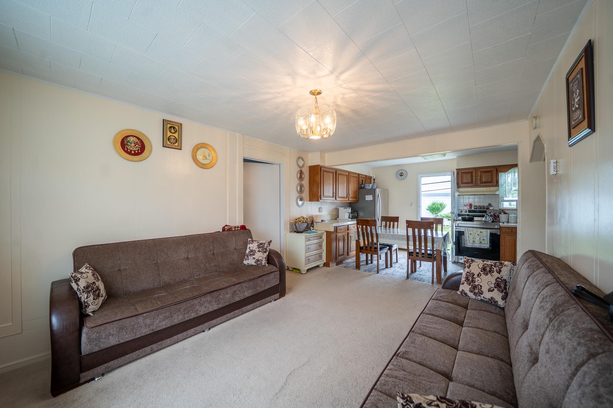 47 Cardinal Road Levittown, NY 11756 - Photo 3 of 27 Living area featuring a chandelier and light carpet