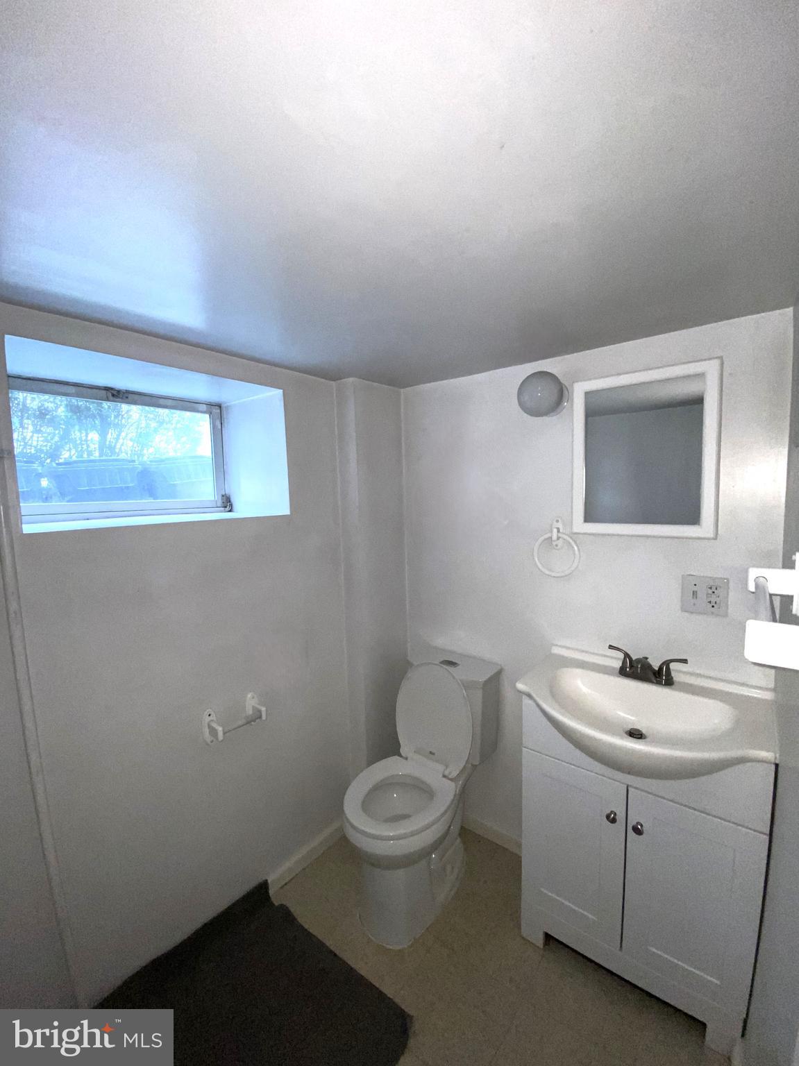435 Nutt Road, Unit 3 Phoenixville, PA 19460 - Photo 4 of 5 a bathroom with a toilet a sink and mirror