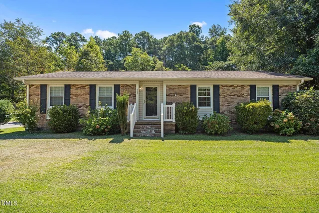 a house that has a tree in front of it