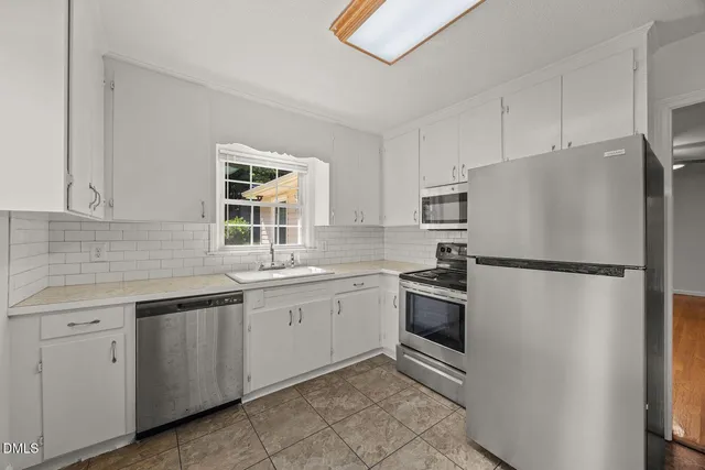 a kitchen with a refrigerator sink and stove