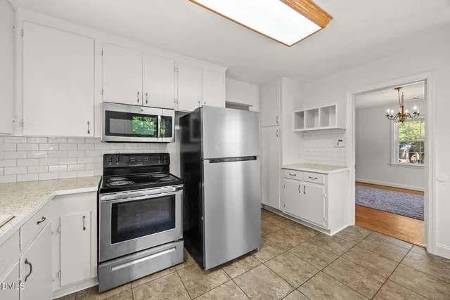 a kitchen with a refrigerator sink and cabinets