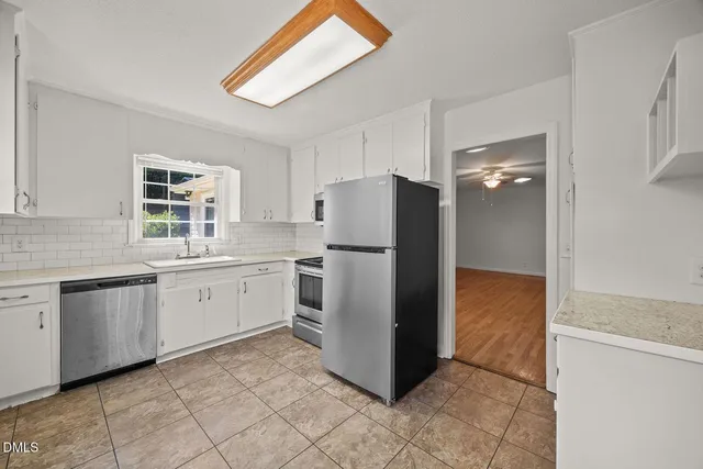 a kitchen with a refrigerator and a sink