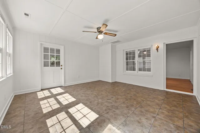 a view of an empty room with windows