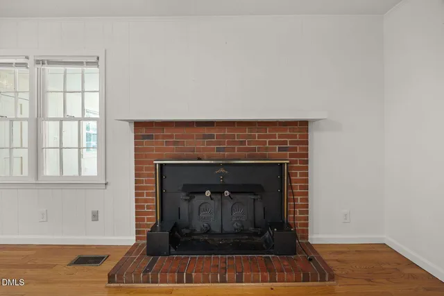 a living room with a fireplace and a rug