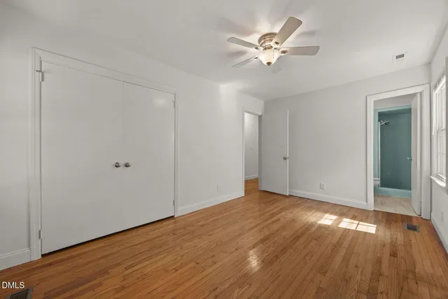 a view of an empty room with wooden floor